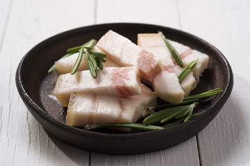 Slices of bacon with rosemary