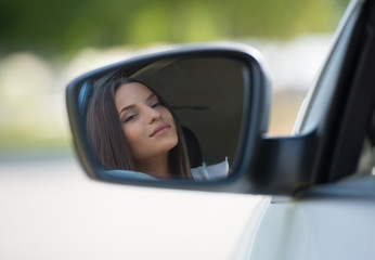 Woman face car mirror