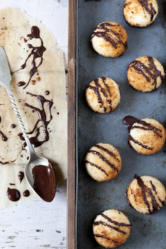 coconut macaroons with dripped dark chocolate with spoon