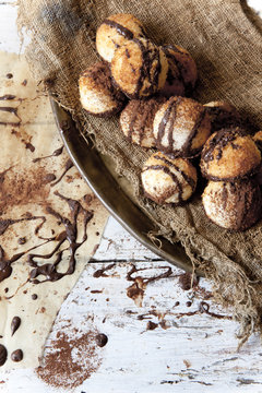 coconut macaroons with dripped chocolate on vintage background