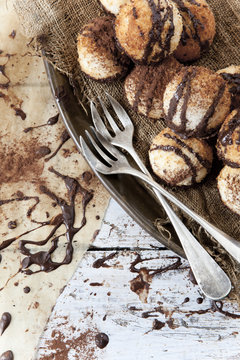 coconut macaroons with dripped chocolate and cocoa with fork