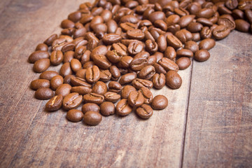 Coffee seeds on wooden surface texture. 