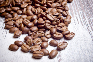 Coffee seeds on wooden surface texture. 