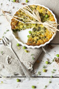 rustic vegetables french quiche on baking dish with fork