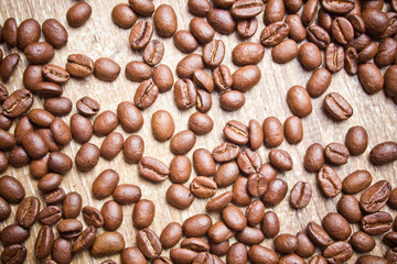 Coffee seeds on wooden surface texture. 