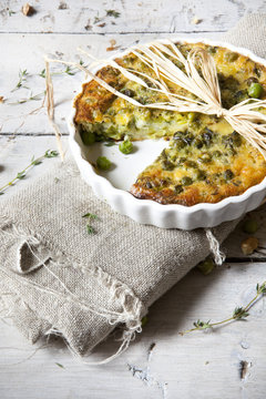 rustic vegetables french quiche with peas on baking dish