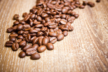 Coffee seeds on wooden surface texture. 