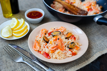 Spanish dish paella with seafood, shrimps in pan