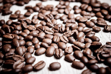 Coffee seeds on wooden surface texture. 