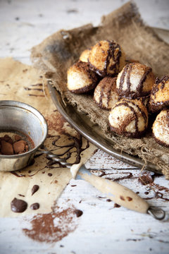 coconut macaroons with dripped dark chocolate and cocoa powder