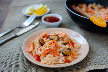 Spanish dish paella with seafood, shrimps in pan
