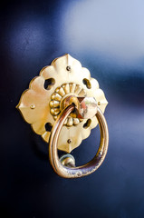 old golden holder on black door