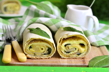 Spinach strudel with omelet and cheese.