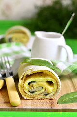Spinach strudel with omelet and cheese.