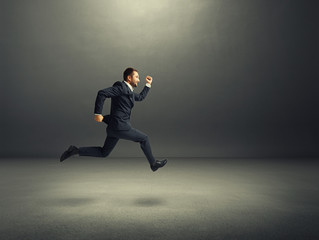 businessman in formal wear running