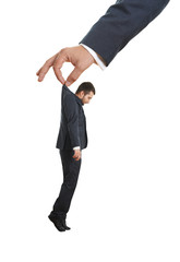 hand holding small sorrowful businessman