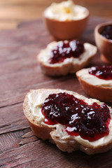 Fresh bread with homemade butter and blackcurrant jam