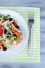 Fresh prawns with spaghetti, olives, tomatoes and parsley in a