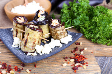 Fried aubergine with cottage cheese in a square plate