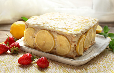 Tasty lemon cake on table at home