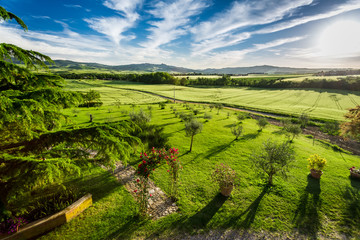 Sunset over the green valley in Tuscany