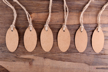 Brown tags on wooden background