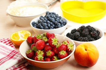Baking tasty pie and ingredients for it on table in kitchen