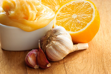 Honey garlic and lemon on wooden rustic table.