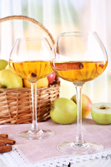 still life with apple cider and fresh apples on wooden table