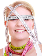 Obsessed fitness woman with a lot of colorful measure tapes