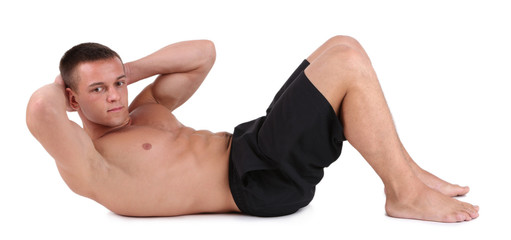 Handsome young muscular sportsman execute exercise isolated