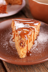 Delicious cake and cup of coffee on wooden table