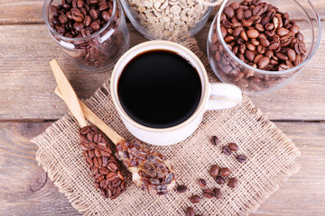 Mug of coffee and jars of coffee beans