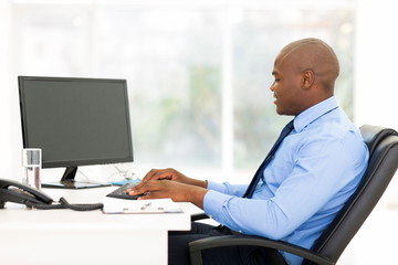 black business man typing on keyboard