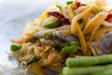 Close-up of papaya salad, which put Pickled Fish and long beans.