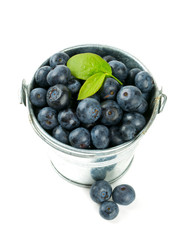 fresh blueberries in a bucket over white