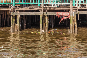 Fototapeta na wymiar Stilts and polluted water