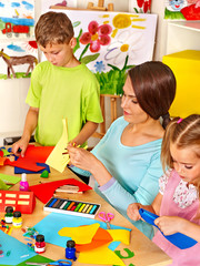 Children with teacher at classroom.