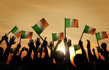 Silhouettes of People Waving the Flag of Ireland