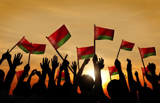 Silhouettes of People Holding Flag of Belarus