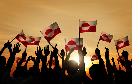 Silhouettes of People Holding Flag of Greenland