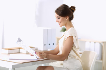 Obraz na płótnie Canvas Attractive businesswoman sitting on desk in the office