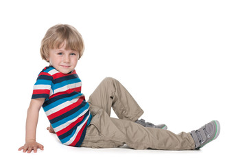 Preschool boy sits on the floor