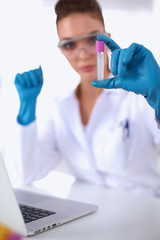 Fototapeta premium Woman researcher is surrounded by medical vials and flasks,