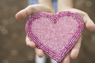 Kids holding a heart toy