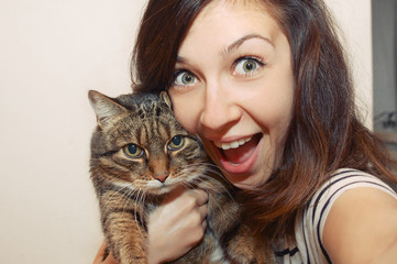 portrait of fuuny smiling girl with cat