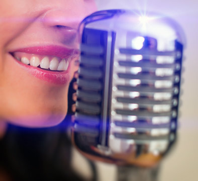 Close-up Of Female Mouth Singing Into Vintage Microphone.