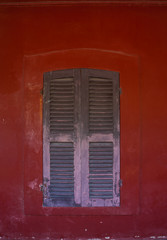 Old wooden window and red walls.