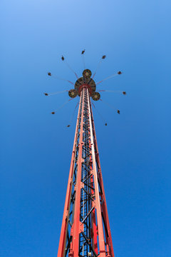 Flying swing carousel against blue sky