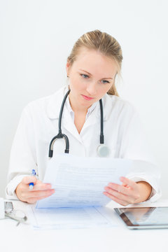 Portrait of female doctor working with documents.